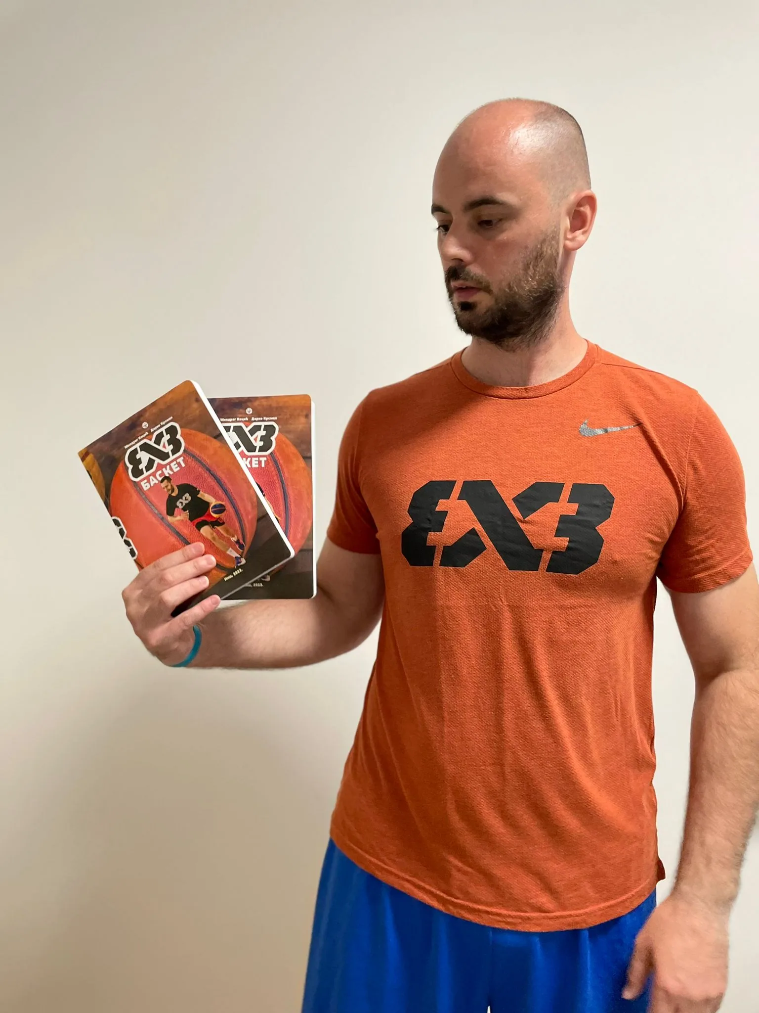Darko Krsman holding 3x3 basketball books